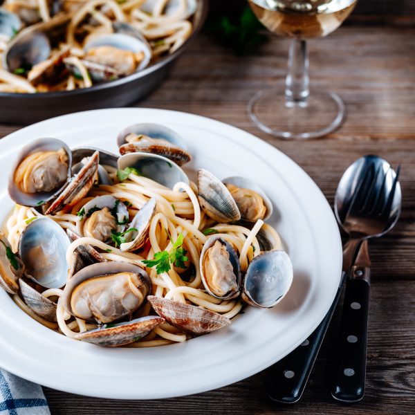 Traditional italian seafood pasta with clams Spaghetti alle Vongole Traditional italian seafood pasta with clams Spaghetti alle Vongole on wooden background